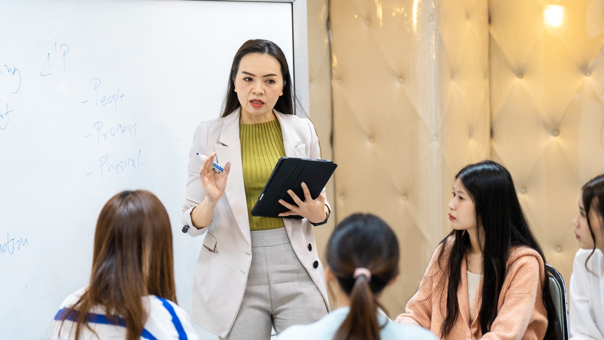 A woman is giving a presentation to a group of women